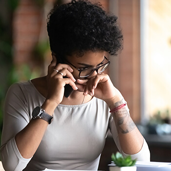 Upset African American woman talking on phone, bad news